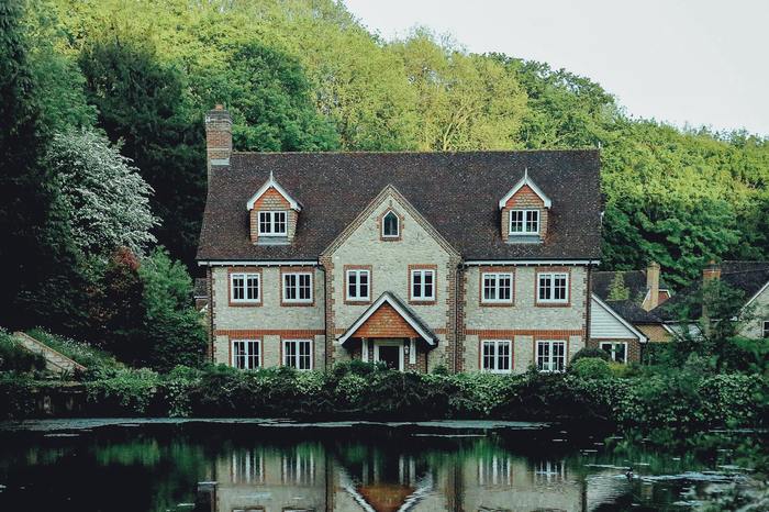 House by lake with surrounded by woodlands | Simon Long Removals Gloucester